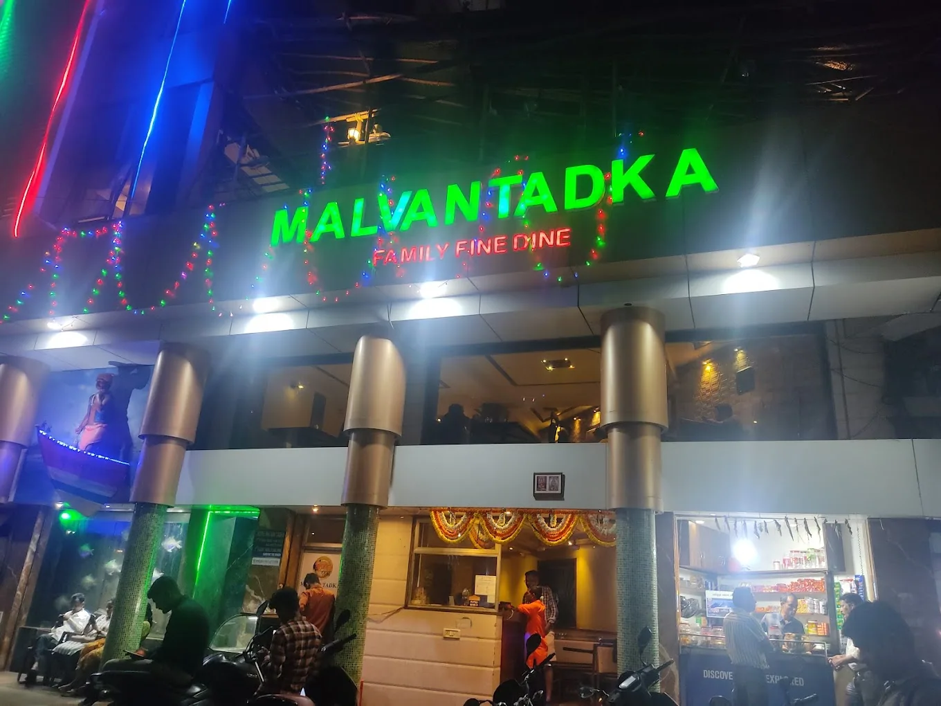 Green neon signage on a family fine-dine facade