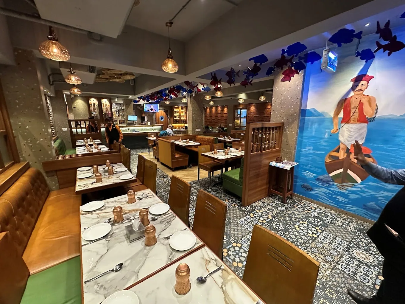 A fisherman mural with blue fish mobiles