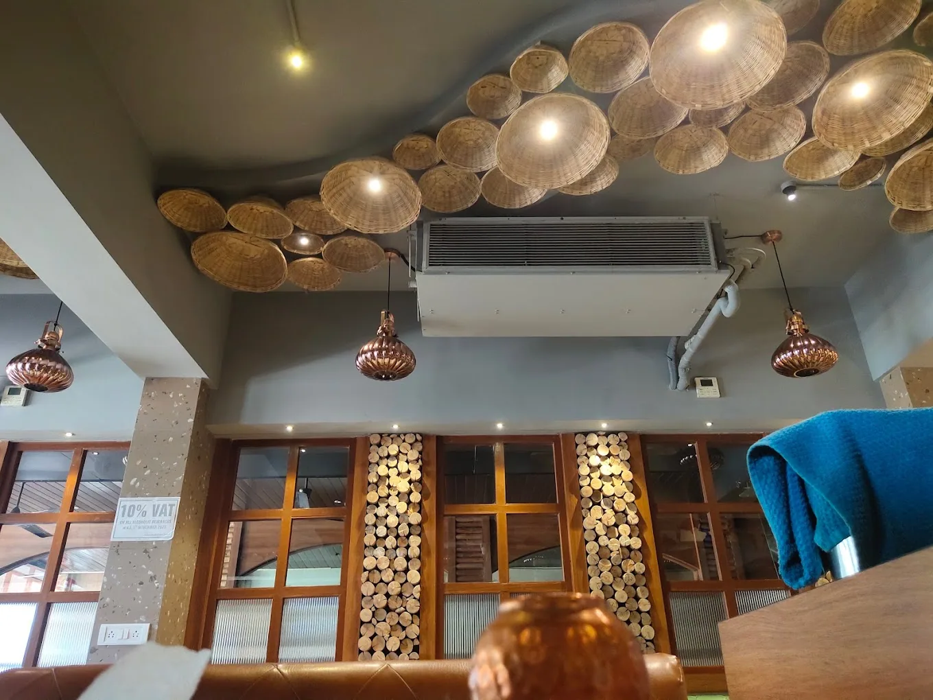 Woven fish-scale pendant lamps across the ceiling